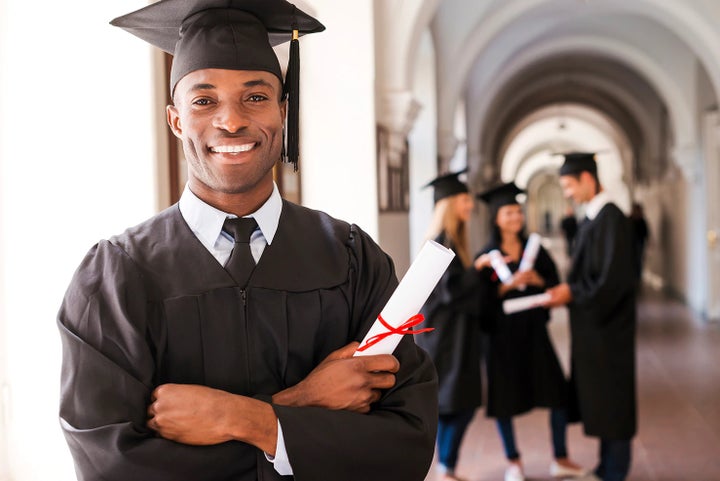 college graduate holding his diploma | Dulles Motorcars Subaru in Leesburg VA
