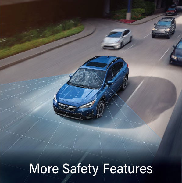 A Subaru Crosstrek in blue with the words &ldquo;More Safety Features&ldquo;. | Dulles Motorcars Subaru in Leesburg VA