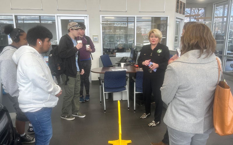 Students standing around a table