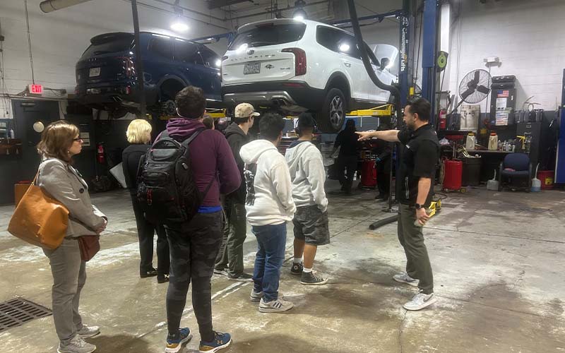 Students taking a tour of the service garage